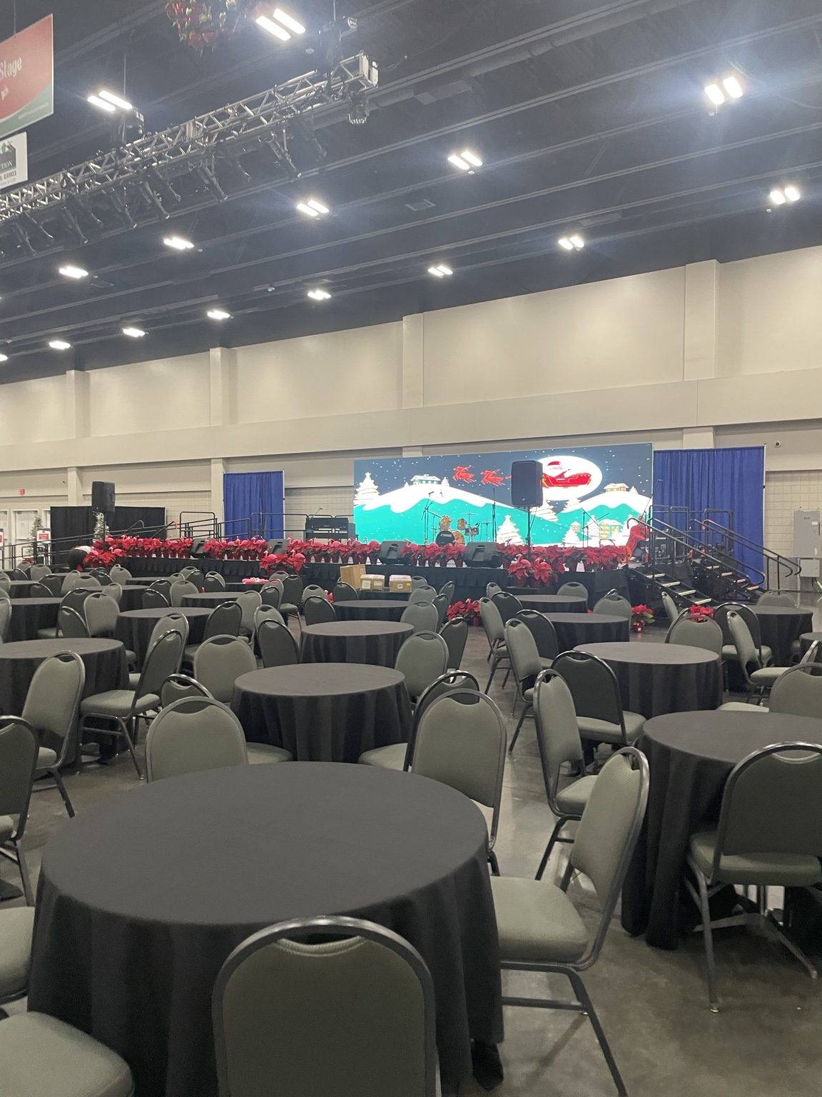 Corporate event room with stage, video, and banquet seating