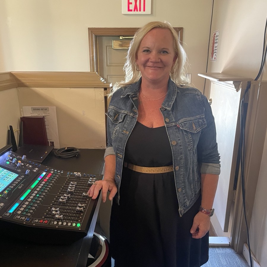Lisa Nunn beside a digital mixing console